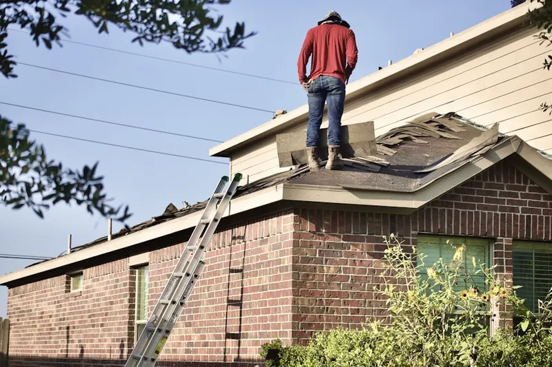 Professional roofer working on a residential roof in Long Pond
